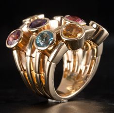 14k Yellow Gold Tourmaline Garnet Citrine Peridot Amethyst Topaz Ring 5.67ctwMetal Information: 14k Yellow GoldTotal Weight: 18.6gBand Width: 5.9mmSize: 6Designer: Sonia BStone InformationMain StoneGem Type: TourmalineShape: Round (5.0mm)Color: PinkClarity/Quality: AA - ACarat Weight: .55ctNumber of Stones: 2Accent StonesGem Type: GarnetShape: Round (5.0mm)Color: RedClarity/Quality: AA - ACarat Weight: .65ctNumber of Stones: 1Accent StonesGem Type: CitrineShape: Round (5.0mm)Color: YellowClarity/Quality: AA - ACarat Weight: .58ctNumber of Stones: 2Accent StonesGem Type: PeridotShape: Round (5.0mm)Color: GreenClarity/Quality: AA - ACarat Weight: .54ctNumber of Stones: 2Accent StonesGem Type: AmethystShape: Round (5.0mm)Color: PurpleClarity/Quality: AA - ACarat Weight: .48ctNumber of Stones: Yellow Gold Multi-stone Fusion Gemstones, Fusion Style Multi-stone Yellow Gold Gemstones, Modern Multicolored Multi-stone Gemstones, Topaz Ring, Citrine, Tourmaline, Garnet, Topaz, Amethyst