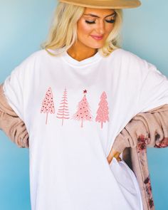 🎄 Pretty in Pink for the Holidays! 🌸 Elevate your Christmas style with our charming Pink Christmas Tree shirt. Perfect for adding a pop of festive elegance to your holiday wardrobe. ✨ Available now to make your season merry and bright. 💖👕 Christmas Pink Cotton Tops, Pink Cotton Christmas Tops, Cute Winter Holiday T-shirt, Cute Holiday T-shirt For Winter, White Winter Tops As Gift, White Winter Tops As Gifts, White Relaxed Fit Christmas T-shirt, White Winter Tops For Gifts, Festive Long Sleeve White T-shirt