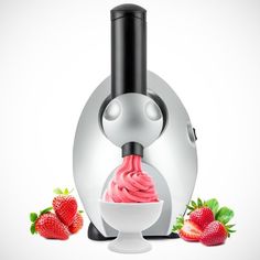 a blender filled with pink ice cream next to some strawberries on a white surface