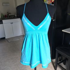 Y2k Nwt Hollister Bright Aqua Babydoll Tank Top. Ties In The Back, Cinched Under Bust, Deep V Neckline, Scattered Lace Overlay On Chest And Bottom Hem. 1st Pic And Last Pic Shows Truest Color! Size Medium, Could Fit A Small As Well. No Flaws. Y2k Stretch Tank Top For The Beach, Y2k Style Stretch Tank Top For Beach, Y2k Halter Neck Cotton Top, Hollister Outfits 2000s, Y2k Sleeveless Beach Tops, Fitted Halter Neck Top For Loungewear, Y2k Stretch Tops For Vacation, Light Blue Tank Top With Built-in Bra For Summer, Blue Fitted Tank Top For Loungewear