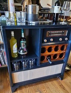 an old fashioned bar with liquor bottles and glasses on the top shelf in front of it