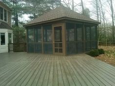 a gazebo sitting on top of a wooden deck