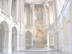 the interior of a church with white walls and columns