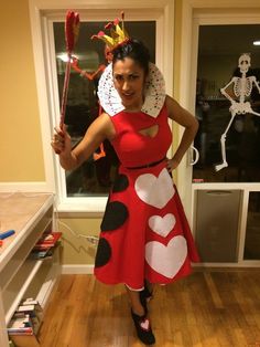 a woman in a lady bug costume poses for the camera with her hands on her hips