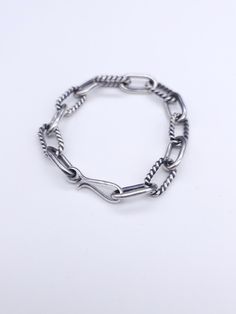 This chain bracelet is made in the style of our plain twist chain necklace. It has an alternating plain round wire link and twist wire link that is certainly going to enhance your style. The finish on the chain has an oxidized finish. It can be a high polished finished upon request. Each link is hand crafted and assembled. Silver Cable Chain Link Bracelet, Silver Oval Link Chain Bracelet With Cable Detail, Silver Cable Chain Bracelet With Oval Links, Sterling Silver Bracelet With Cable Chain Design, Classic Silver Cable Chain Bracelet, Silver Oval Link Chain Bracelet Minimalist Style, Minimalist Silver Oval Link Chain Bracelet, Silver Cable Chain Bracelet, Silver Chain Bracelet With Hook And Links For Everyday