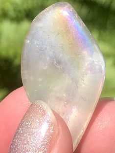 Tumbled Angel Aura Quartz Stones Peace Angel Aura Quartz or Rainbow Aura Quartz cleanses the aura and can help to facilitate meditation. This is a very peaceful stone which can help the wearer communicate with Angels and Spirit Guides. This stone will help you clear away the negativity in your life. It will also raise the energy level of anyone who has been feeling depleted. Angel Aura Quartz can help you release negative emotions, such as resentment and grief. Stones measures 1 to 1 and 1/2 inc Iridescent Healing Spiritual Crystals, Iridescent Spiritual Healing Crystals, Spiritual Iridescent Healing Crystals, Spiritual Tumbled Crystals For Meditation, Rainbow Aura Quartz, Rainbow Aura, Angel Aura Quartz, Angel Aura, Aura Quartz