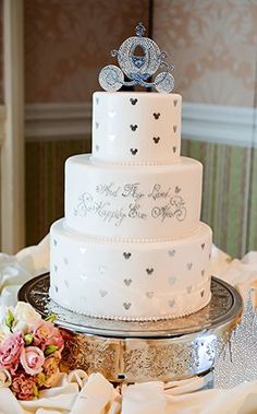 a three tiered wedding cake sitting on top of a table