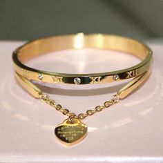 The Forever Love Bracelet Is The Perfect Combination Of Boujee And Classy. Wear This Bangle On A Night Out Or Add Some Glamour To Your Everyday Style, The Versatility Is There. A Piece That Is Truly Timeless And Made To Last You For Many Years. High-Quality 316l 18k Gold Plated Stainless Steel High-Quality Platinum Plated Stainless Steel Inner Diameter: 2.5" X 2" Perimeter: 17cm Water Resistant Tarnish Free Elegant Gold Heart-shaped Bangle, Valentine's Day Dainty Bangle Bracelets, Elegant Adjustable Stainless Steel Heart Bracelet, Elegant Metal Heart Bangle Bracelet, Stainless Steel Bangle Bracelet For Valentine's Day, Elegant Stainless Steel Heart Bracelet For Anniversary, Rose Gold Metal Heart Bangle Bracelet, Elegant Metal Charm Bracelet For Mother's Day, Dainty Promise Bracelets For Valentine's Day