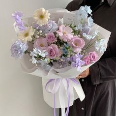 a man holding a bouquet of flowers in his hands