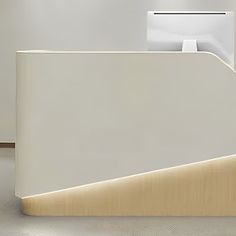 a white reception desk with an open door on the front and back side, in a modern office setting