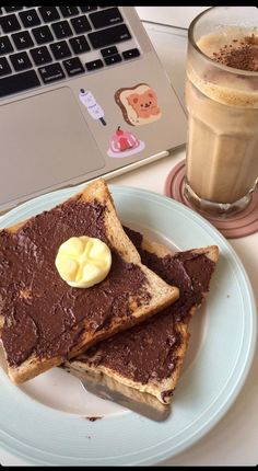 two pieces of toast on a plate with butter and chocolate