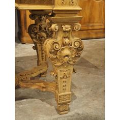 an old wooden table with ornate carvings on it