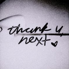 graffiti writing on the side of a building that says, thank u next to it