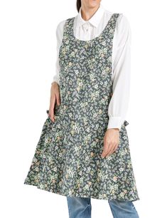 a woman wearing an apron with flowers on the front and back, standing against a white background