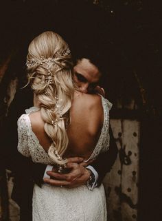 a man and woman embracing each other in front of a wooden wall with the words instagram on it