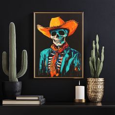 a painting of a skeleton wearing a cowboy hat and scarf on a shelf next to cacti