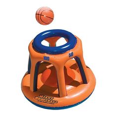 an inflatable basketball game with a ball coming out of the basket and on top of it