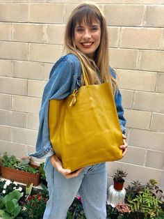 Large tote leather bag in MUSTARD YELLOW. Large shopper bag natural GENUINE leather. Large enough for books or a laptop, tablet, cosmetics bag etc. Leather shopper. The inside of the bag is not lined (although properly finished!) . We added a small leather pouch on the inner part of the bag . The bag can be closed by 2 leather straps attached to each side. Excellent quality soft but strong genuine leather. Width upper part: 41cm - 16 inch Height: 38 cm - 15 inch (CAMEL COLOR AS ON THE FIRST 3 PI Small Leather Pouch, Tote Leather Bag, Tote Bag Outfit, Yellow Leather Bag, Large Shopper Bag, Yellow Tote Bag, Yellow Soft, Cosmetics Bag, Genuine Leather Bags