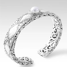 Sarda Is Luxury Designer Jewelry Made By Hand In Bali And Designed By Janyl Sherman. This Oval Cuff Bracelet Is Intricately Made By Hand Out Of Solid .925 Silver With A White Freshwater Pearl Bezel Set In The Center. It Has A Retention Hinge To Make It Easier To Get On And Off. The Size Is 7.” This Fits A 6.25”-7.25” Wrist. It’s Also A Little Over 0.5” Wide, And It’s Close To 0.25” Thick! This Bracelet Has A Lot Of Silver! It Weighs 44.5 Grams!!! There Are 28.35 Grams Of Silver In An Ounce. Oval Sterling Silver Cuff Bracelet Gift, Silver Sterling Silver Oval Cuff Bracelet, Bohemian Silver Oval Cuff Bracelet, Traditional Silver Carved Cuff Bracelet, Nickel-free Oval Sterling Silver Bracelets, Sterling Silver Cuff Bracelet, Sterling Silver Cuff, Silver Cuff Bracelet, Pearl Color