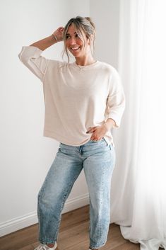 Elevate your casual wardrobe with the Evening Stroll Sweater Top, a versatile and chic piece that transitions effortlessly from day to night. This top is crafted in a soft cream knit that exudes subtle elegance. Its crew neckline is complemented by wide ribbed detailing, while the dropped shoulder seams and slouchy sleeves add to its laid-back vibe. The cozy knit texture gives it a timeless, casual charm, making it perfect for layering or wearing solo on cool evenings. Fabric: 100% Cotton Produc Versatile Relaxed Fit Knit Top For Loungewear, Relaxed Cream Tops For Fall, Chic Relaxed Fit Knit Top For Everyday, Beige Knit Top For Loungewear, Effortless Relaxed Fit Sweater For Everyday, Effortless Relaxed Fit Everyday Sweater, Cream Soft Knit Tops For Layering, Chic Soft Knit Top With Relaxed Fit, Oversized Knit Top