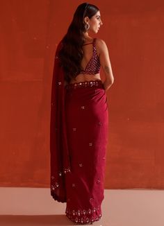 Featuring a maroon silk saree embellished with mirror and tonal silken thread work. It is paired with a sleeveless blouse with mirror and thread work in jaal pattern along with tassel tie-up at the back.Composition : Saree & Blouse: SilkCare: Dry Clean Only and Vacuum Storage All products can be customised for sleeves, length of blouse and neck design Delivery : 4-6 weeks as the product is hand crafted. Check Size Guide or choose MySize for free customisation (All Sizes above XL can be made at 15% additional cost) For more information and sizes please contact fabiliciousfashion@gmail.com or visit our Copenhagen studio.About the Designer : Angad Singh's journey in the world of fashion started with at an early age as he grew up in a family business that was immersed in couture. Seeking to ex Maroon Silk Saree, Mirror Work Saree, Mirror Embroidery, Padded Blouse, Vacuum Storage, Hem Blouse, Work Sarees, Wedding Destination, Mirror Work