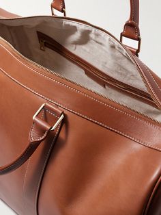 Bottega Veneta's quiet luxury is centred around craftsmanship and tradition. Made in Italy from supple 'washed' leather, this 'Cabin' duffle bag is sized to hold your clothes and essentials for a weekend getaway, with a few pockets for stowing smaller items. Carry it by hand or over the shoulder using the detachable strap. Luxury Cognac Weekender Bag For Everyday, Elegant Duffle Bag With Leather Lining For Daily Use, Luxury Vegetable Tanned Leather Shoulder Bag For Travel, Classic Travel Tote Bag With Smooth Grain, Luxury Vegetable Tanned Leather Travel Shoulder Bag, Elegant Formal Weekender Bag With Smooth Grain, Classic Rectangular Weekender Bag With Smooth Grain, Elegant Weekender Bag With Smooth Grain For Formal Use, Elegant Smooth Grain Weekender Bag For Formal Use