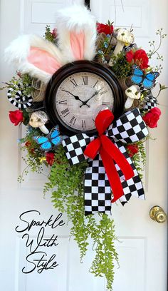 a clock decorated with feathers and flowers on the front door to welcome you into spring