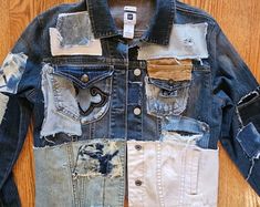 an old jean jacket with multiple patches and holes