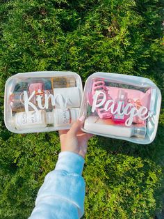 someone is holding two plastic containers with personalized items in them