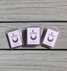 three waxed candles sitting on top of a wooden table