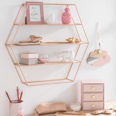 the shelves are organized in pink and gold