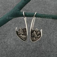 These are not large: about 1 inch from the top of the hook to the bottom of the picture frame. Makes these perfect for all day wear.Each earring is slightly different: left side/right side. Pine trees, a river, all in a mountain setting. They are inspired by the wonderful Cascade mountains where I live. Solid sterling silver; I make each pair by hand with love and care.It is possible to do these in solid gold.  If interested, please inquire.These will arrive on an earring card, and in a recycled Nickel-free Sterling Silver Nature-inspired Earrings, Engraved Sterling Silver Drop Earrings, Sterling Silver Jewelry With Ear Wire For Anniversary, Sterling Silver Earrings With Silver Clasp For Anniversary, Mountain Stamp, Mountain Jewelry, Fairytale Fashion, Mountain River, Cascade Mountains