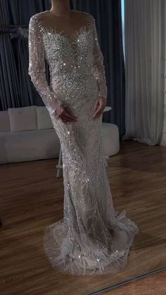 Luxury Silver Nude Mermaid Arabic Evening Dress: Elegance in Long – Larosabride Elegant Mermaid Dress With Long Train For Banquet, Luxury Festive Evening Dress With Fitted Bodice, Mermaid Hem Gown For Wedding And Gala, Elegant Party Gown With Intricate Embroidery, Luxury Dress For Festive Banquet, Elegant Long Sleeve Mermaid Dress For Wedding, Luxury Banquet Gown With Sweep Train, Elegant Long Sleeve Mermaid Wedding Dress, Long Sleeve Mermaid Wedding Dress With Fitted Bodice