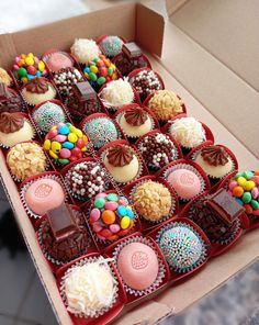 a box filled with lots of different types of chocolates on top of each other