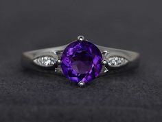 Welcome to my shop, you can find many beautiful gemstone jewelry here, and you also can ask for customized service. Main Stone: natural amethyst, round cut 7X7mm, weighs about 1.24 caratsAccent Stones: czMetal: 925 sterling silver plated with rhodium. I also can provide metal options such as 14k solid yellow/white/rose goldSetting: prong settingmore rings: https://www.etsy.com/shop/XCjewelryStudio?ref=hdr_shop_menuIt's quite comfortable for wearing and suitable for all occasions (wedding, annive Sterling Silver Amethyst Ring With Accent Stones, Elegant Amethyst Birthstone Ring In Round Band, Elegant Amethyst Birthstone Ring With Round Stone, Elegant Amethyst Birthstone Ring Round Band, Elegant Purple Crystal Ring With Prong Setting, Elegant Purple Birthstone Ring With Round Cut, Classic Round Solitaire Amethyst Ring, Elegant Purple Round Cut Birthstone Ring, Classic Amethyst Round Cut Birthstone Ring