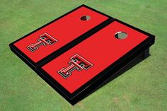 two red and black cornhole tossers on green grass with the word, fps