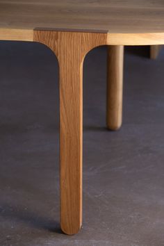 a wooden table sitting on top of a cement floor