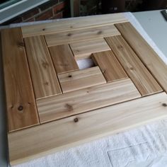 a wooden cutting board sitting on top of a white towel