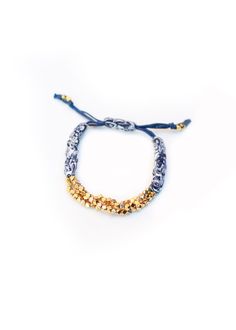 "Gold Cluster Nugget Bracelets are handmade in New York City with Indigo Bandana. Prasada in Sanskrit means \"God's Blessing\". Nugget is a symbol of good fortune. This Prasada bracelet is a nice gift with great intention for yourself and your beloved.  It adds a romantic bohemian touch to your wrist to complete a casual chic look. The length of the bracelet is adjustable." Spiritual Beaded Bracelets For Friendship And Festivals, Handmade Jewelry For Friendship Festivals, Adjustable Spiritual Bracelets For Festivals, Bohemian Bracelets With Gold Beads For Gifts, Handmade Adjustable Charm Bracelet For Festivals, Adjustable Charm Bracelet With Gold Beads, Gold Spiritual Friendship Bracelets For Festivals, Adjustable Gold Beaded Wristband, Traditional Adjustable Stretch Bracelet Gift