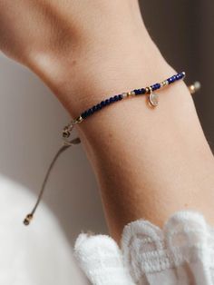 Discover our lapis gold bracelet, a dainty lapis lazuli beaded bracelet, moonstone, gold plated details and a sparkling blue topaz charm. This blue gemstone bracelet for women is ideal to combine with its matching choker, with any white or blue garment or with a bohemian or minimalist style. Of course, it is also perfect to give as a gift as a birthstone or for the upcoming Christmas holidays.  ** D E T A I L S ** Gemstones size we use are lapis lazuli and white moonstone 2mm, blue topaz charm 3 Gold Arm Band, Blue Gemstone Bracelet, Blue Stone Bracelet, December Birthstone Jewelry, Lapis Lazuli Crystal, Lapis Lazuli Bracelet, Lapis Lazuli Beads, Gold Armband, Blue Stones