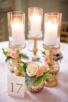 there are candles on the table with flowers in vases next to eachother