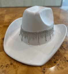 cowgirl hat, rhinestone hat, western hat, cowboy hat, women's hat, fashion hat, bling hat, party hat, festival hat, rodeo hat, sparkle hat, ranch hat, trendy hat, **Title   Women's Cowgirl Hat with Rhinestones - Sparkly Western Hat for Fashion, Festivals, Rodeos, and Parties **Product Description   Turn heads with our Women's Cowgirl Hat with Rhinestones. This stylish hat combines classic western design with sparkling rhinestone embellishments, creating a unique and fashionable accessory. Perfect for adding a touch of glamour to any outfit, this hat is ideal for festivals, rodeos, parties, or everyday wear. Made from high-quality materials, it offers a comfortable fit and long-lasting durability. Whether you're dressing up for a special occasion or adding flair to your casual look, this rh Western Bling Hat For Rodeo, Western Hats With Bling For Rodeo, Western Style Bling Hats For Rodeo, Western Flat Brim Party Hats, Western Style Hat With Bling And Curved Brim, Western Flat Brim Hats For Party, Country Style Rhinestone Hats For Rodeo, Brimmed Hats With Rhinestones For Country Events, Western Wide Brim Felt Hat For Party