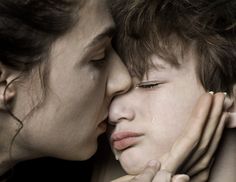 two women kissing each other with their faces close together