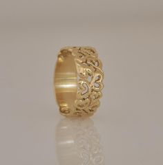 "This 14k gold ring, is unique and very special wedding band. This wide gold ring is full of \"love hearts\" dancing and swirling in random order. This ring can be a wonderful anniversary gift for the one you love. Each heart is meticulously hand crafted and is inimitable and different from all the other. Three full hearts complement the hollow ones around the band. The ring has a solid, plain, smooth bottom part for extra comfort. The ring is wide but has a light and gentle appearance. It can b Anniversary Rings With Decorative Wide Band, Elegant Wide Band Wedding Bands, Yellow Gold Wide Band Engraved Wedding Ring, Engraved 14k Gold Wide Band Ring For Wedding, Thick Band 14k Stamped Wedding Jewelry, Anniversary Wide Band Ring With Decorative Details, Anniversary Wide Band Ring With Decorative Band, Heirloom Wide Band Engraved Ring For Wedding, Heirloom Engraved Wide Band Ring For Wedding