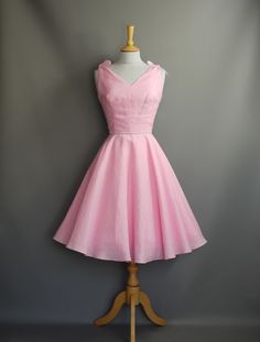 Made from a light weight linen and coupled with tie straps gives this pretty summer dress, a perfectly whimsical feel. The fitted darted bodice has an informal V neckline that dips to a low 'V' at the back. The fitted waistband, highlighted by a contrasting grey cotton piping and a full circle skirt is both flattering and relaxed in style.  The sash with a small bow detail is not included in the order. This dress is ready made and available off-the-peg in a size UK 12 (US 8/EU 40). It has been m Dig For Victory, Pretty Summer Dress, Pretty Summer Dresses, Rose Bonbon, Full Circle Skirt, Full Circle Skirts, Pink Linen, Candy Pink, Full Circle