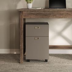 a computer desk with a laptop on top of it