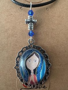 Beautiful religious artwork of Virgin Madonna  pendant by Arte Lilia and handmade by Karen G . Spiritual Our Lady Of Guadalupe Pendant Necklace, Traditional Handmade Crucifix Necklace, Spiritual Crucifix Necklace For Memorial, Handmade Memorial Necklace With Oval Pendant, Our Lady Of Guadalupe Round Pendant As Gift, Bohemian Crucifix Necklace, Bohemian Crucifix Necklace As Gift, Bohemian Crucifix Necklace As A Gift, Handmade Spiritual Cross Necklace