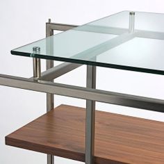 a glass table with metal legs and shelves