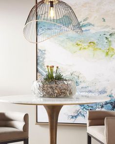 a table with a plant on it and a birdcage hanging over it's top