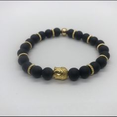 Gold Buddha And Black Beads Combination Creating A Great Piece Of Jewelry For Any Occasion Handmade Black Crystal Bracelet In Spiritual Style, Handmade Black Crystal Bracelet For Spiritual Purposes, Handmade Black Crystal Bracelet For Spiritual Use, Handmade Black Crystal Bracelet For Spiritual Healing, Handmade Black Crystal Bracelet, Black Beaded Bracelet Gift, Casual Black Beaded Wristband, Adjustable Black Beads For Gifts, Adjustable Black 8mm Beads